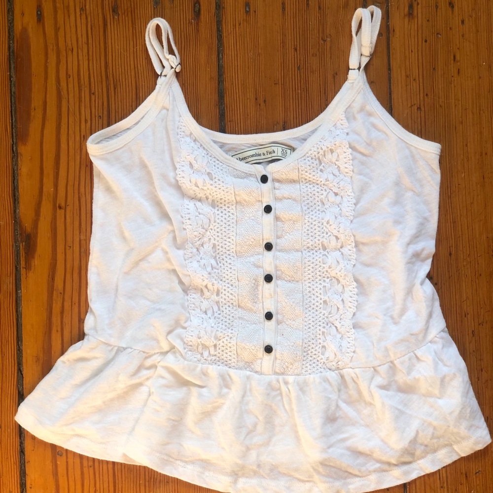 A flowy white tank top with lace and buttons